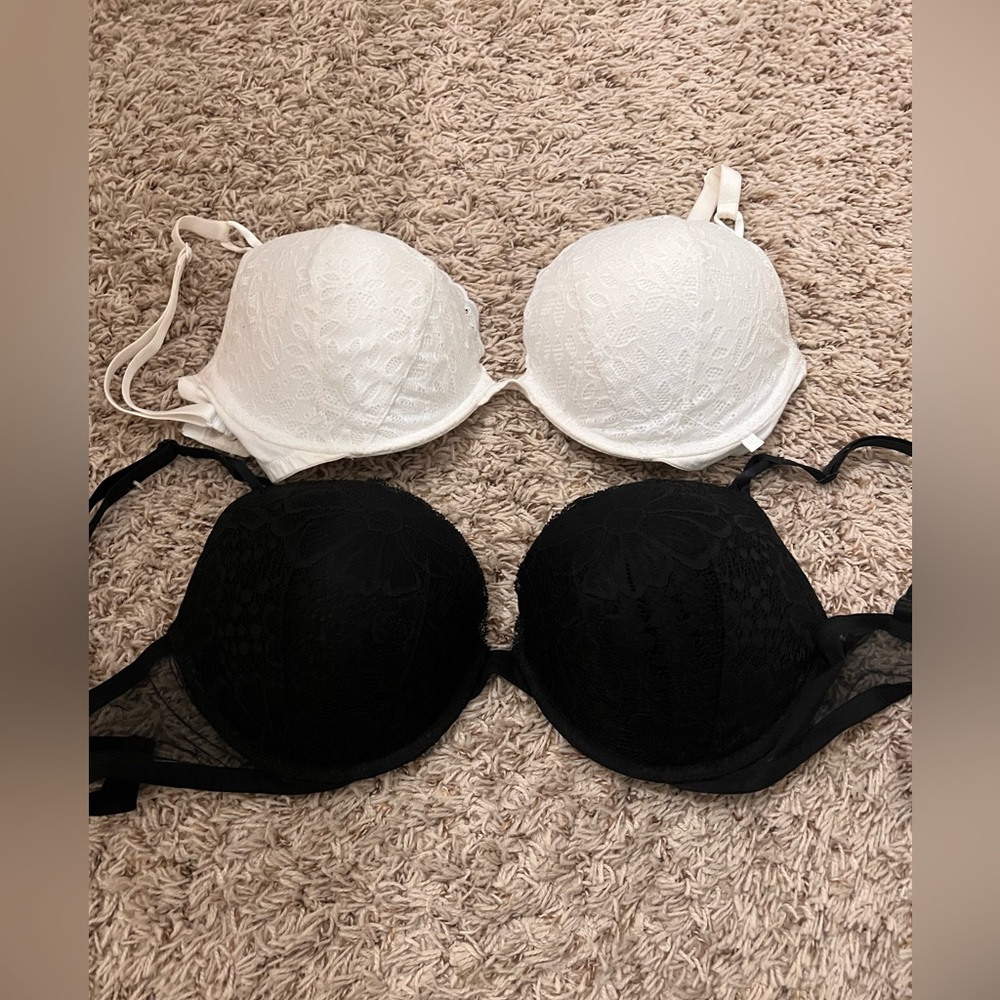 Two black and white Victoria Secret push up bras size 36DD